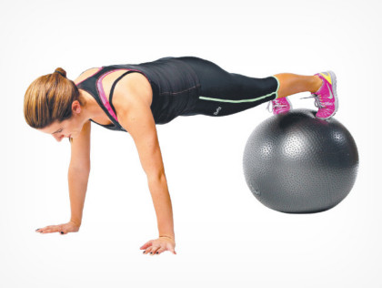 Woman doing exercise ball plank