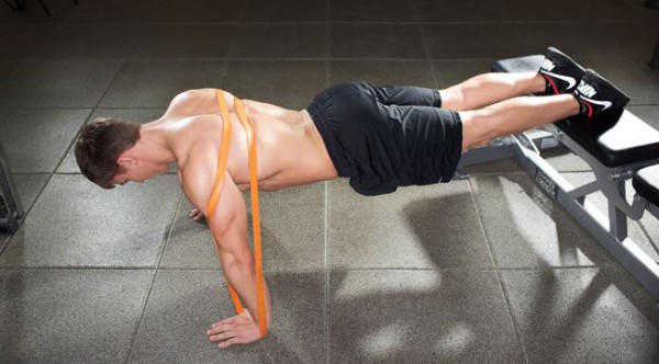 Man doing a push up with a resistance band